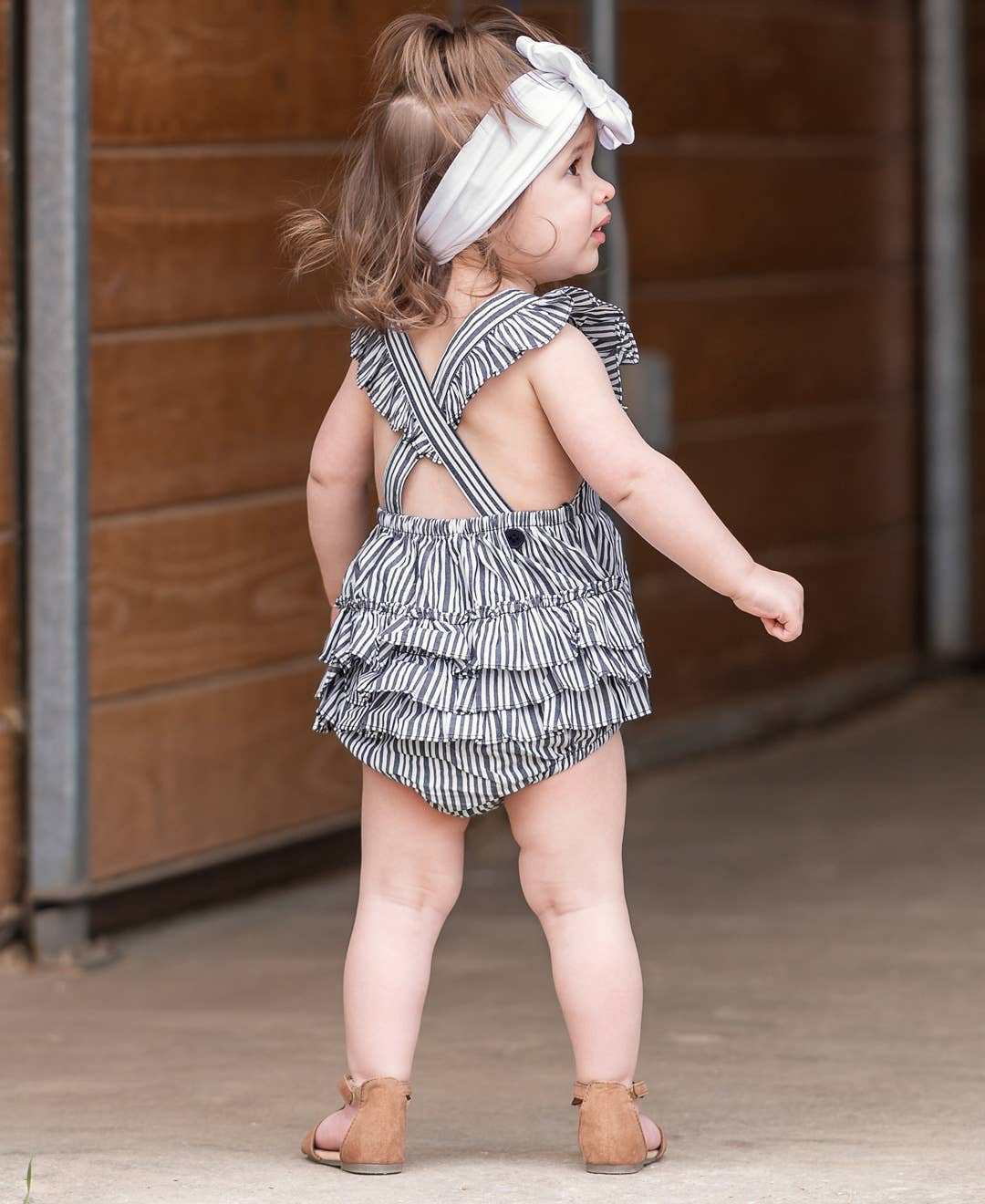 RuffleButts + RuggedButts - Baby Girls Navy Micro Stripe Woven Pinafore Cross-Back Bubble Romper